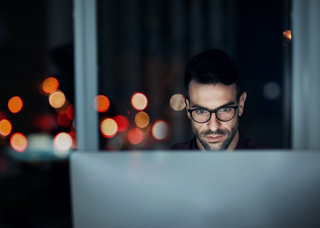 man with glasses at desk