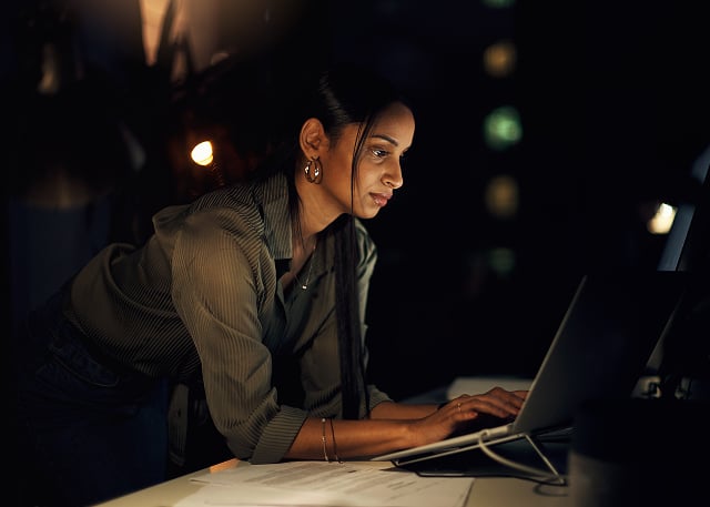 woman leaning on desk